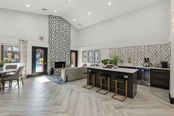 A living room with a kitchen and a fireplace